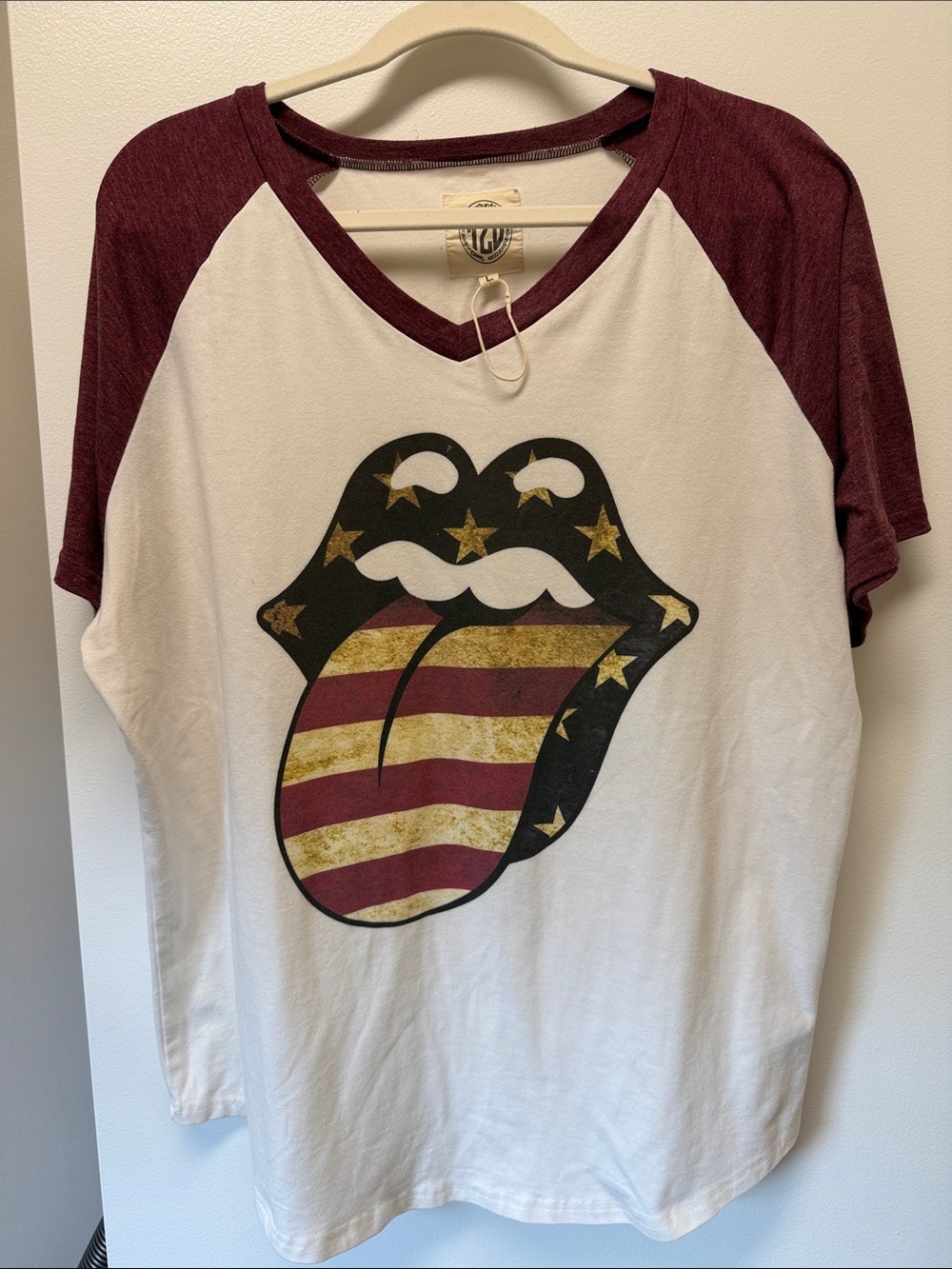 This is a Rolling Stones raglan t-shirt featuring a distressed American flag ton
